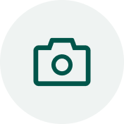 Camera icon in a green circle on a white background