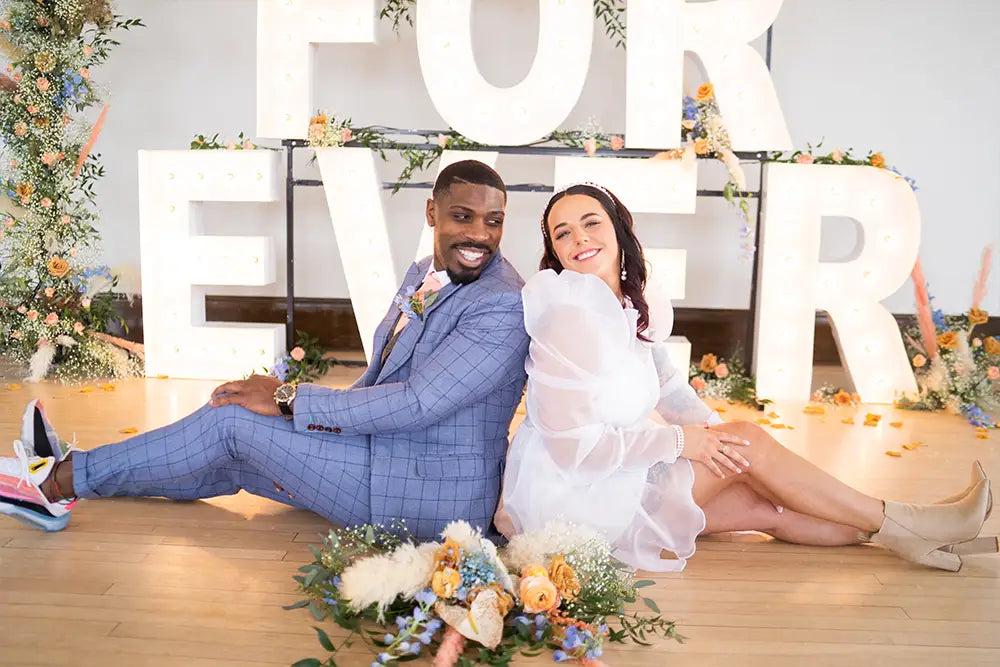 groom in light blue suit with bride
