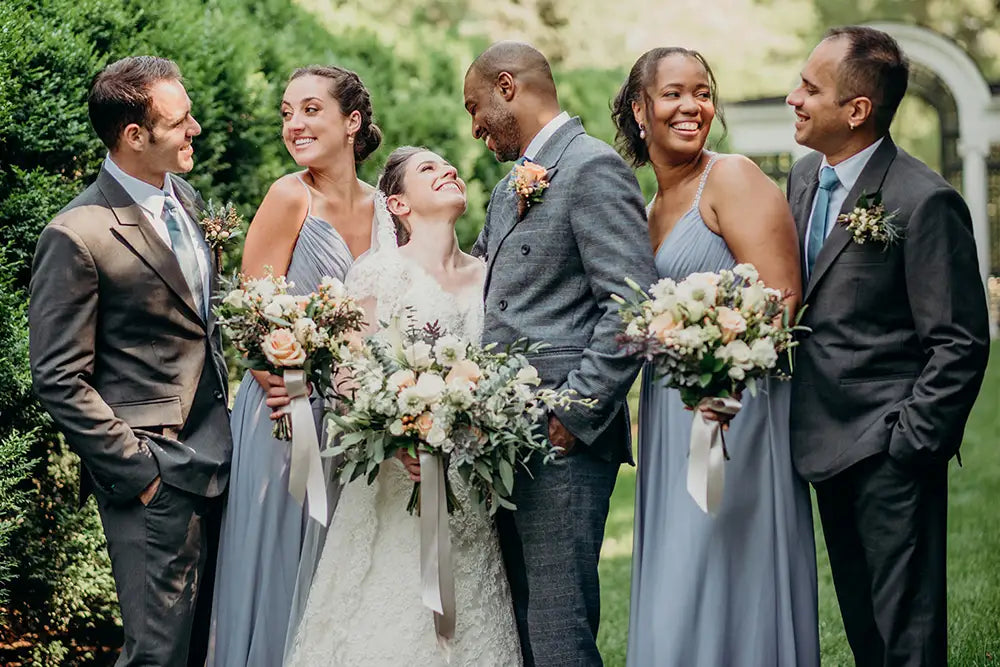 groom in grey prince of wales suit with bride and groomsmen in charcoal suits