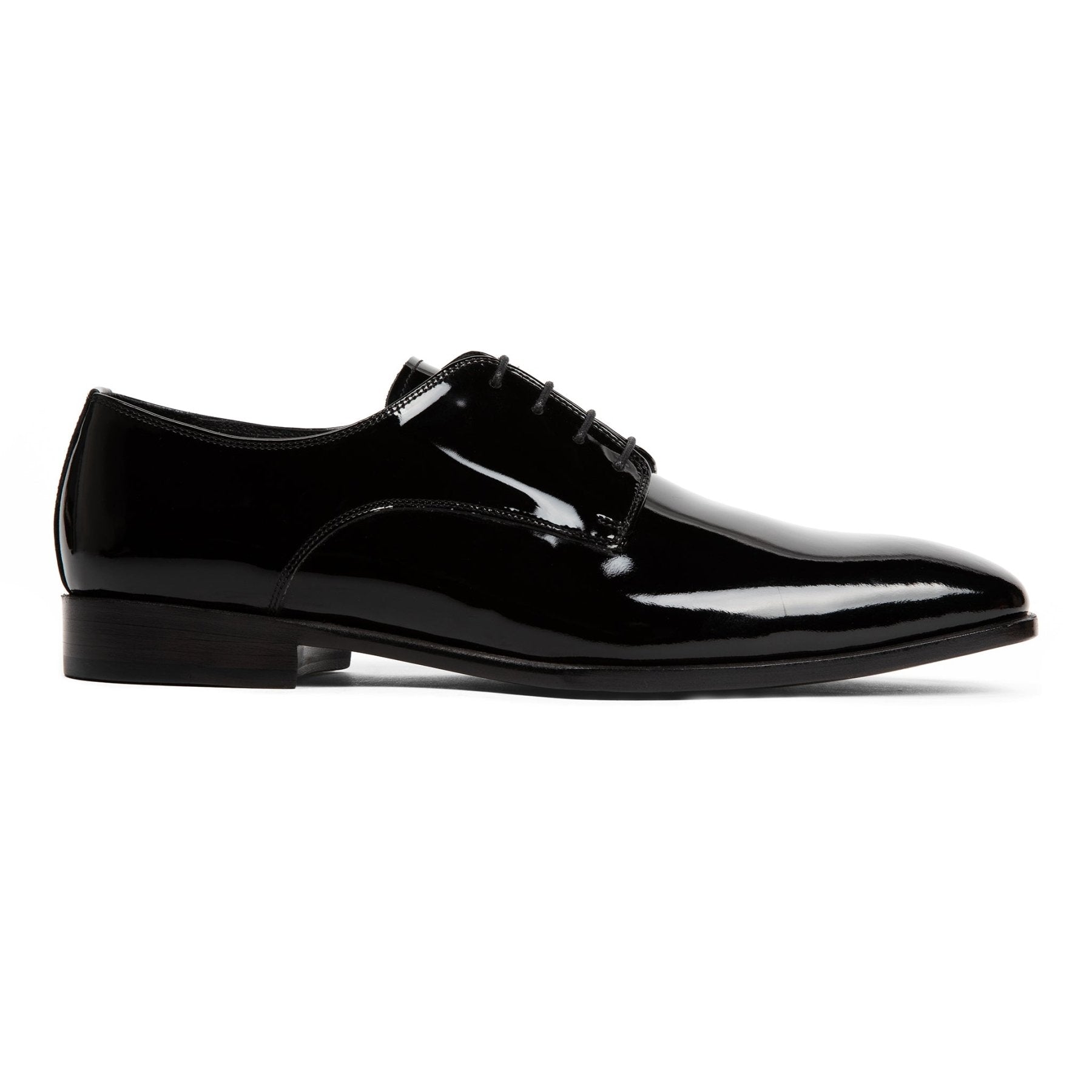 Black patent leather dress shoe on a white background