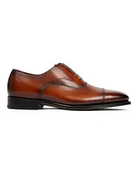 Brown leather dress shoe on a white background