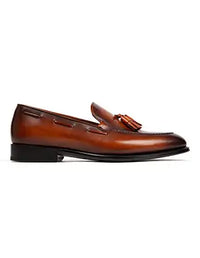 Brown leather loafer with a tassel on a white background