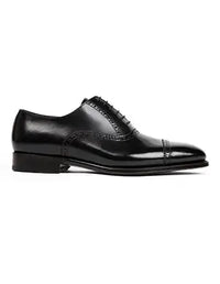 Black leather dress shoe on a white background
