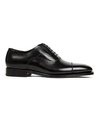 Black leather dress shoe on a white background