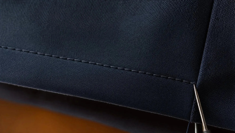 Clean, even stitching on a trouser hem is the first thing to check after a test alteration — loose threads or uneven spacing signal rushed work that will not hold on a suit jacket
