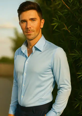 Man wearing a light blue shirt with a blurred natural background