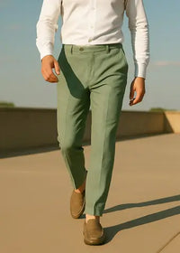 a man walking in jade green linen pants