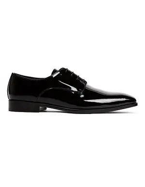Black patent leather dress shoe on a white background