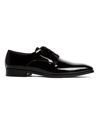 Black patent leather dress shoe on a white background