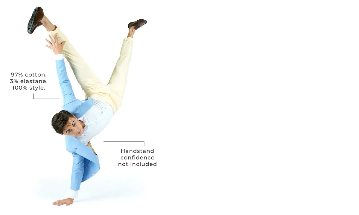 Person in light blue shirt and beige pants performing a handstand on a white background