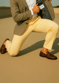 a man in yellow pants doing a big stretch