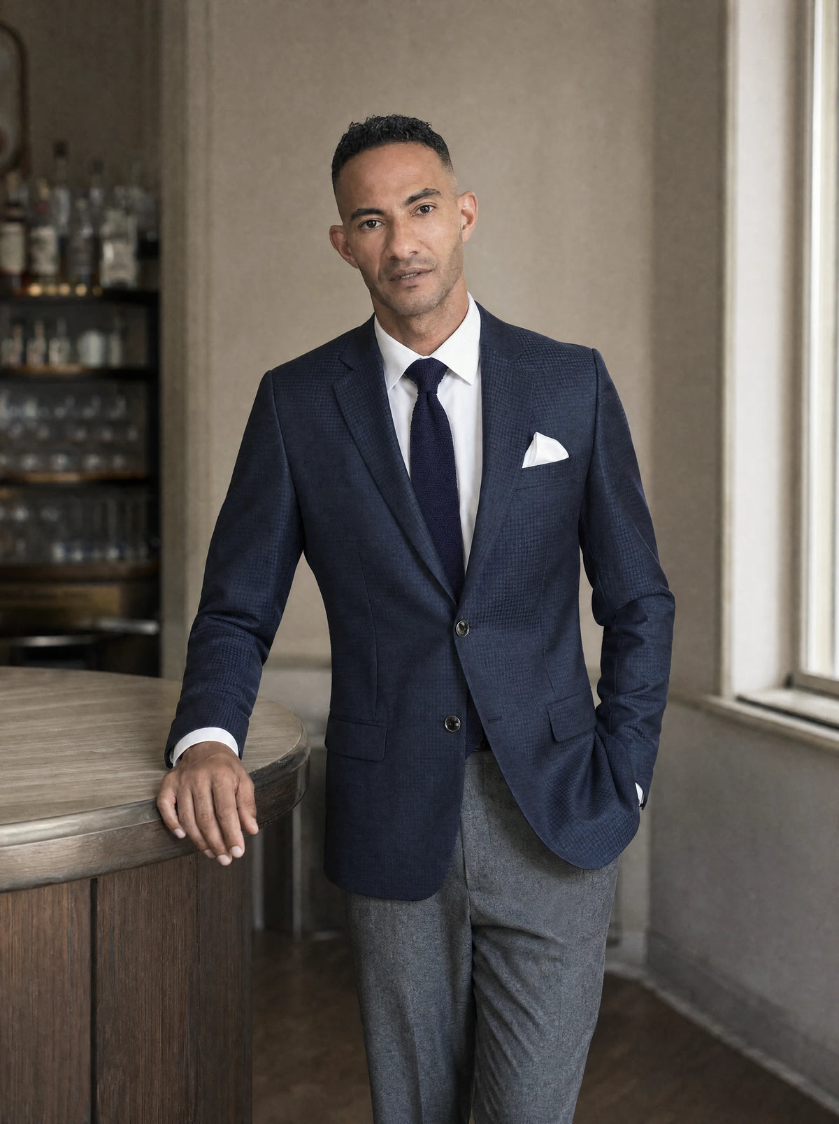 Graphite Blue Microcheck Jacket worn by a model, hotel bar afternoon502