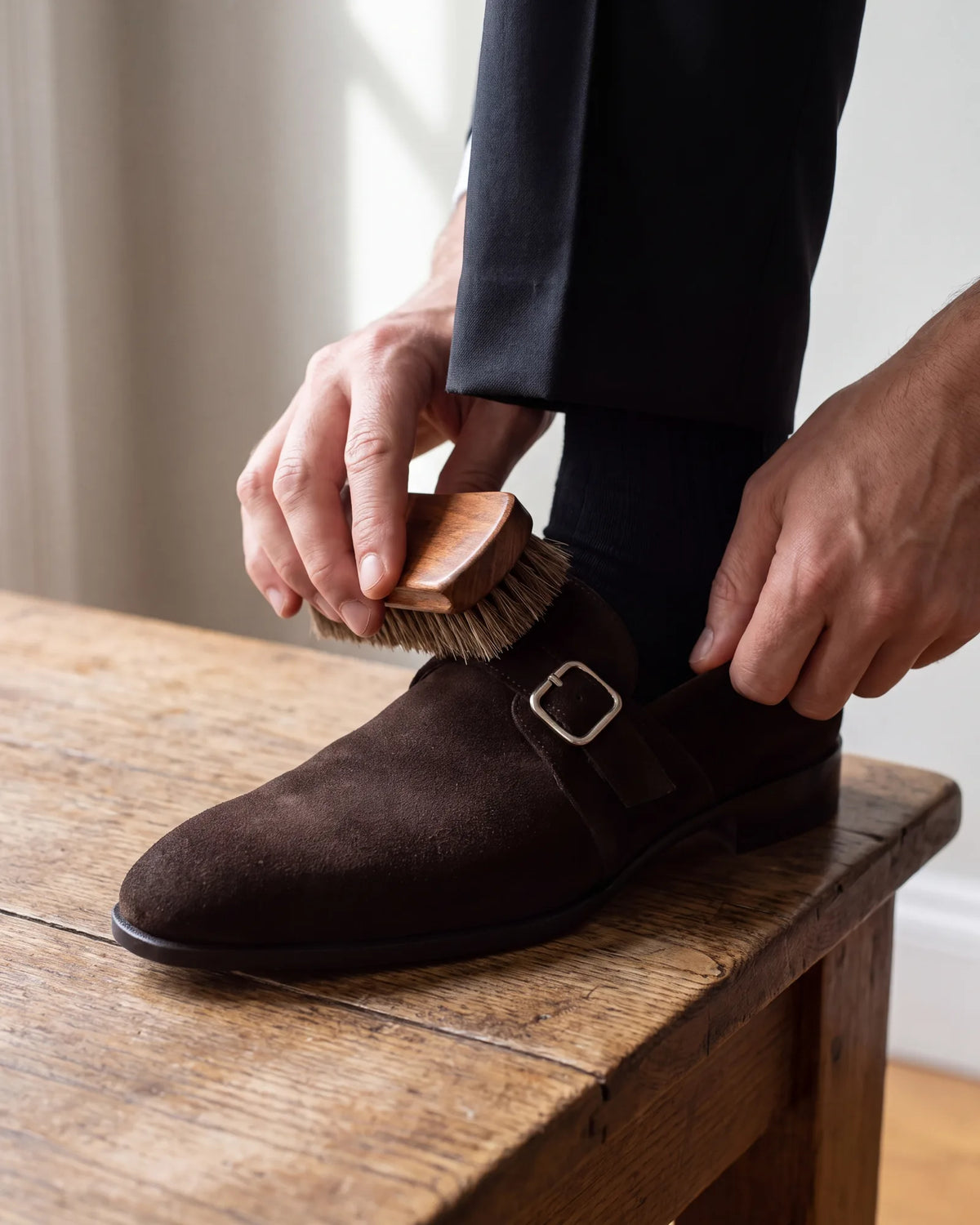 Brushing keeps a suede monk strap from looking worn, and worn shoes pull down the whole outfit.