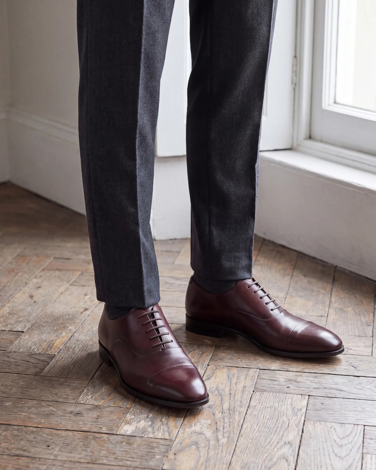 Shoe color moves an oxford up or down. Black leans formal, so save black oxfords for finance, law and client days.