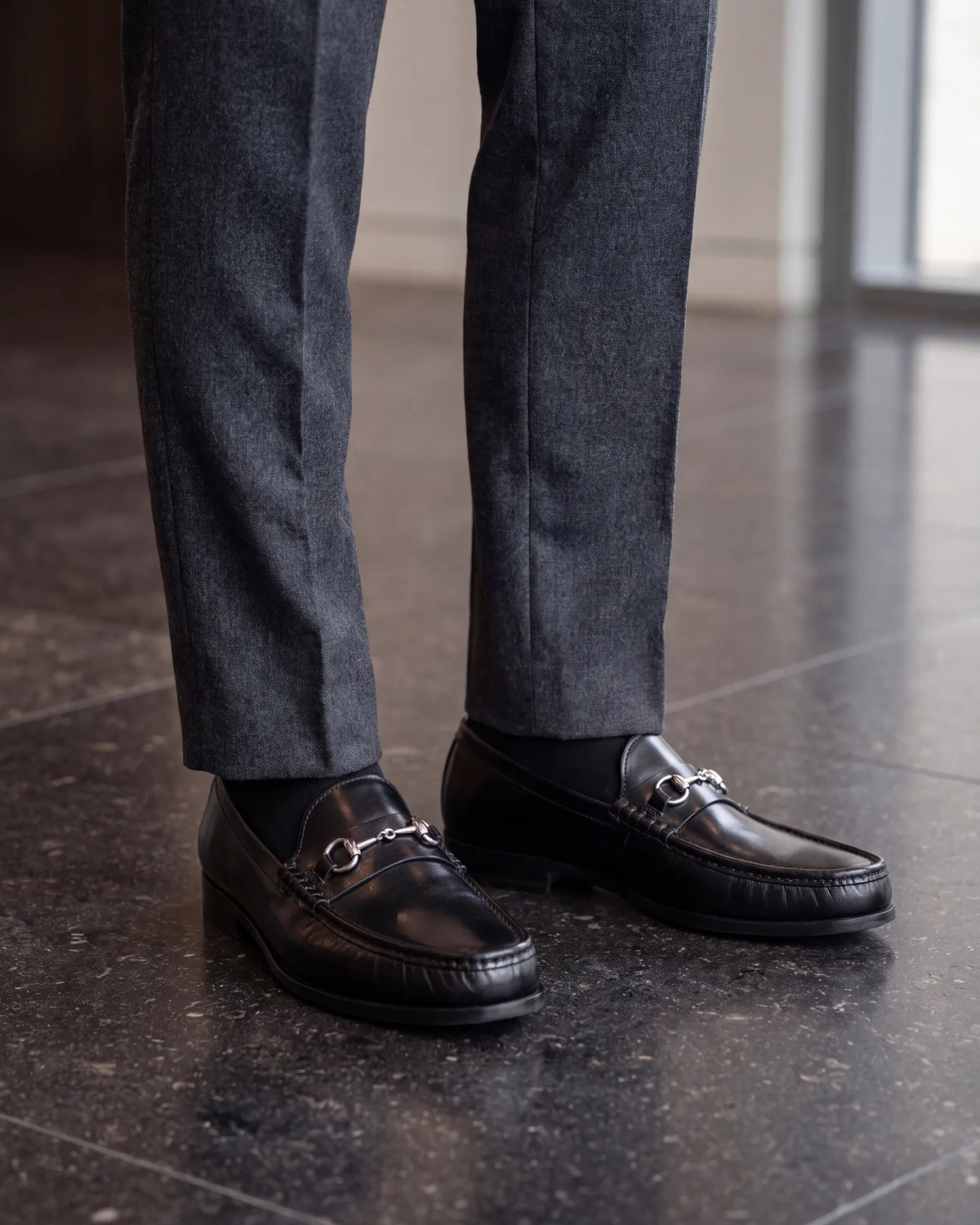In finance and law, smooth black or dark brown loafers keep the outfit as formal as the office expects.
