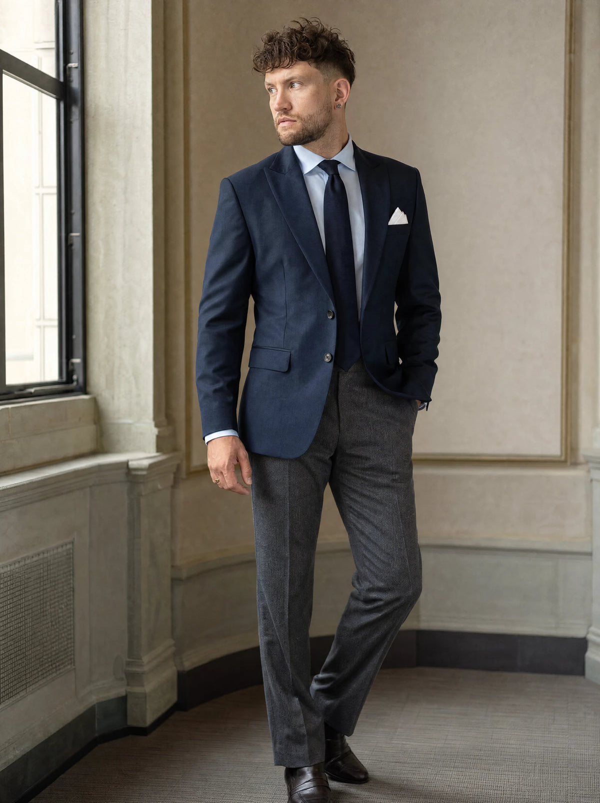 Bryant Navy Sharkskin Jacket worn by a model, bank office window231