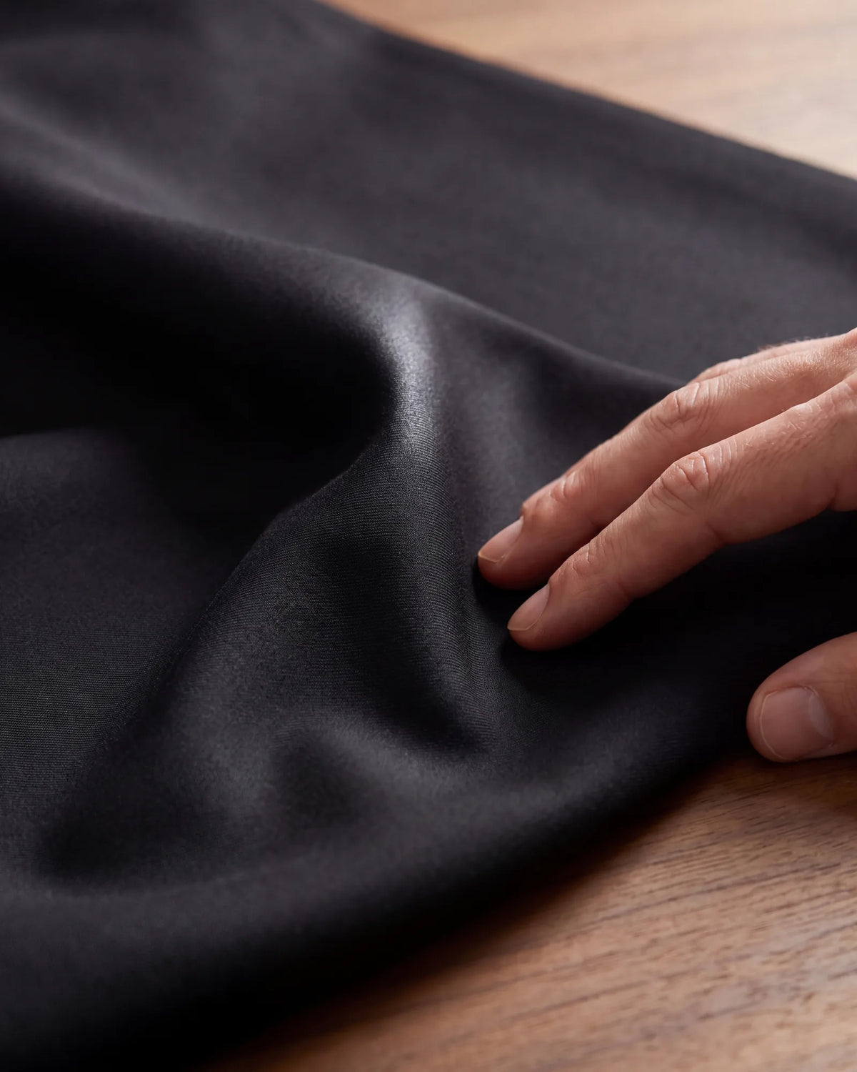 Choose a smooth, flat worsted for black. A faint sheen along the fold is the look to expect.