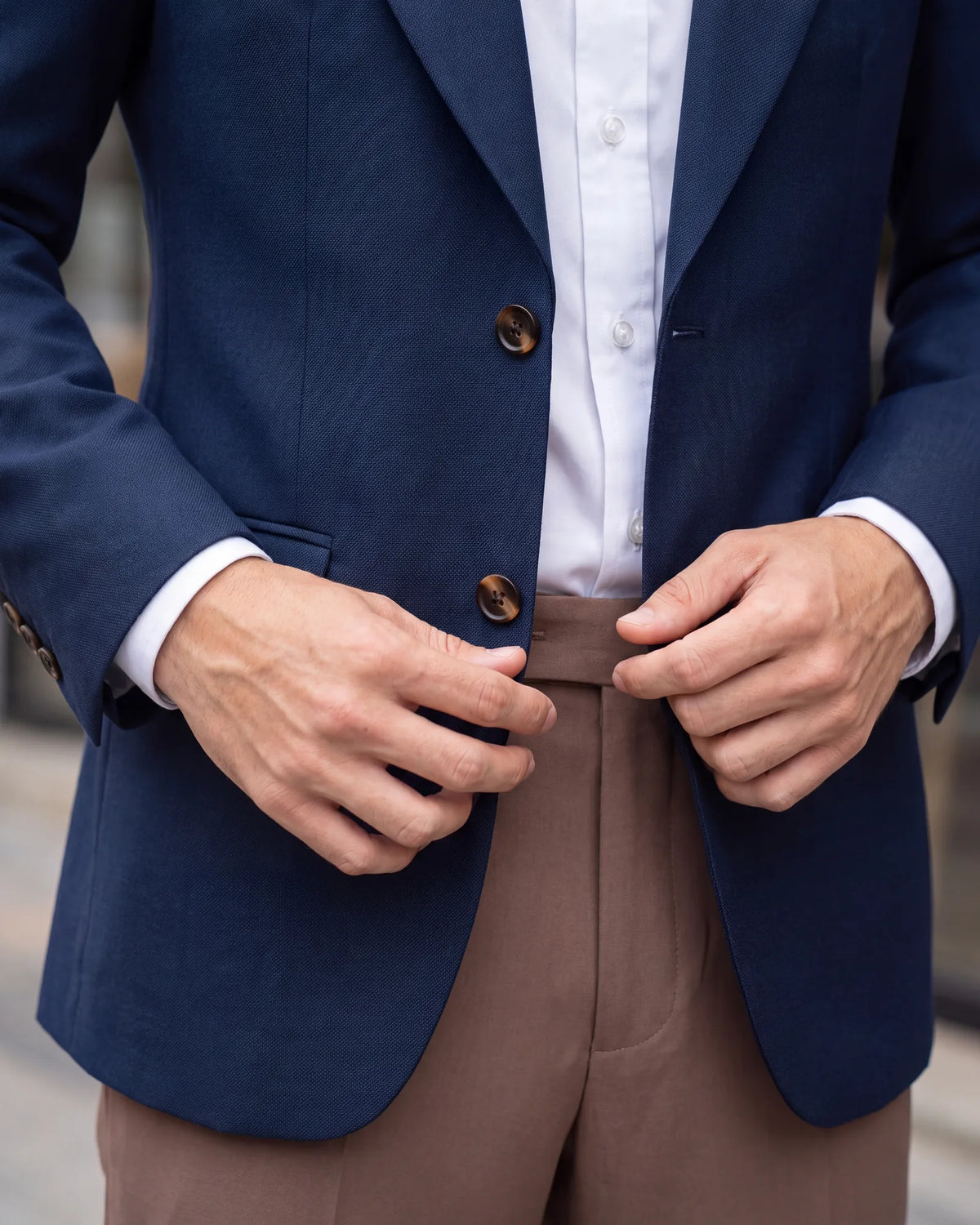 Look for two things on a blazer: buttons that contrast with the cloth, and a solid cloth with a light texture, such as hopsack or serge.