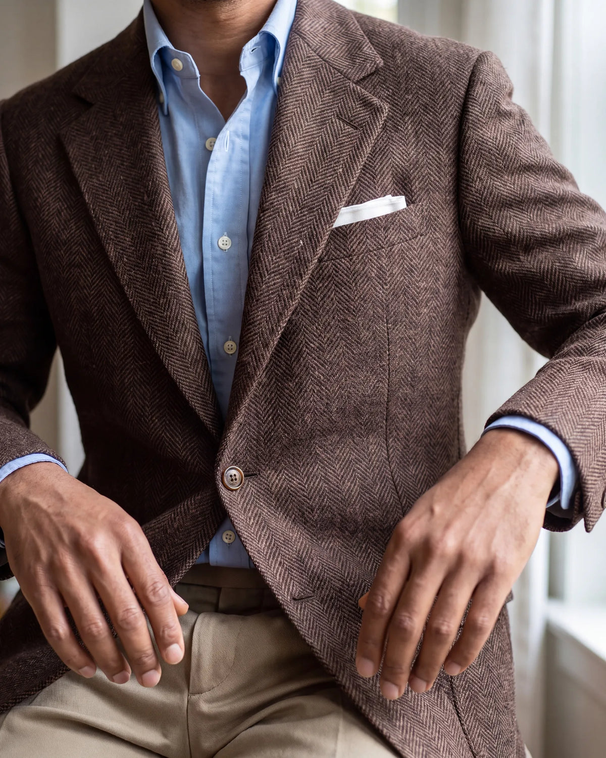 Look past the weave to the details: horn or leather buttons and a softer, roomier cut are usual on a sport coat.