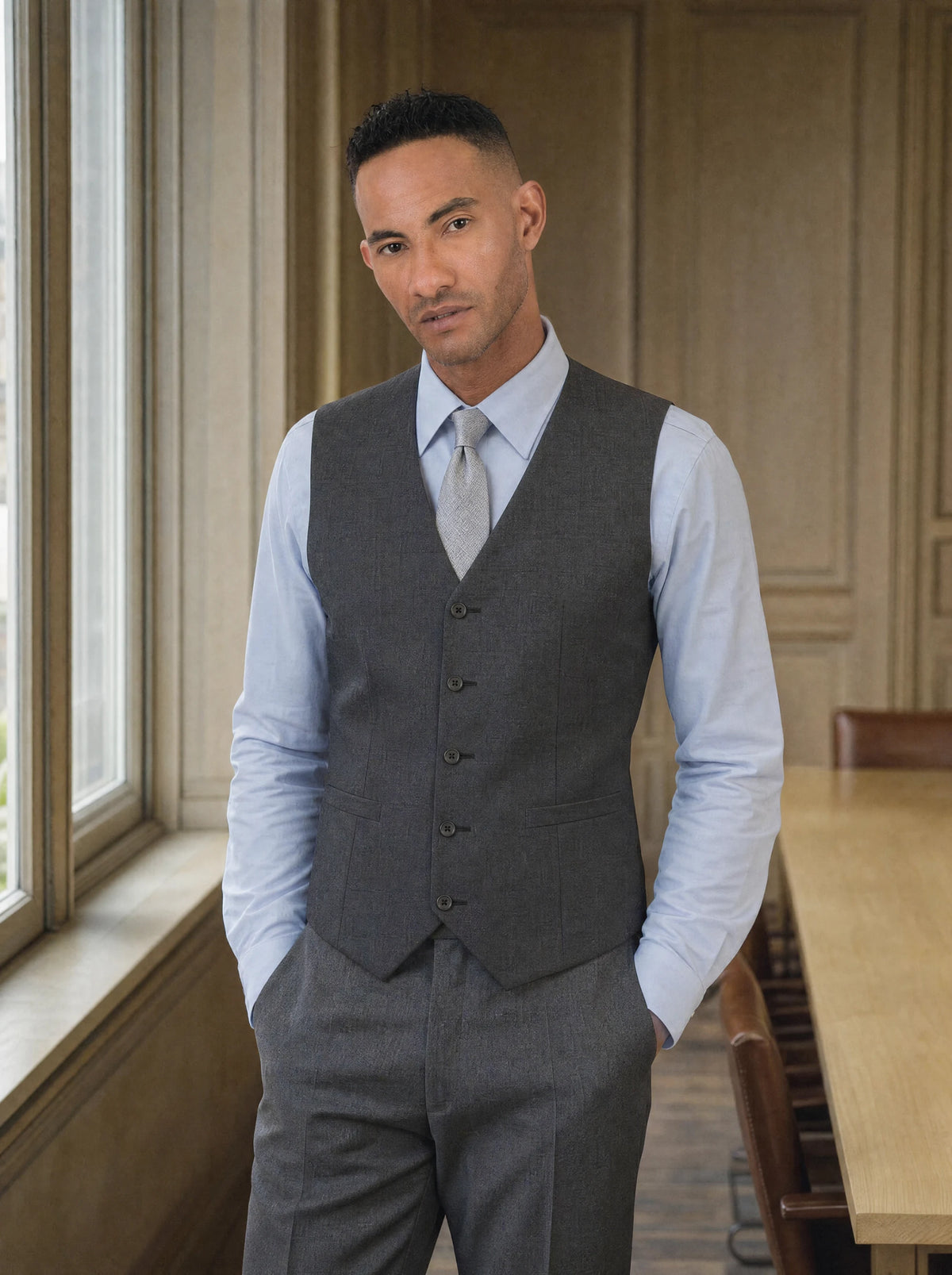 Man in a charcoal crosshatch waistcoat and pale blue shirt in a law firm boardroom799