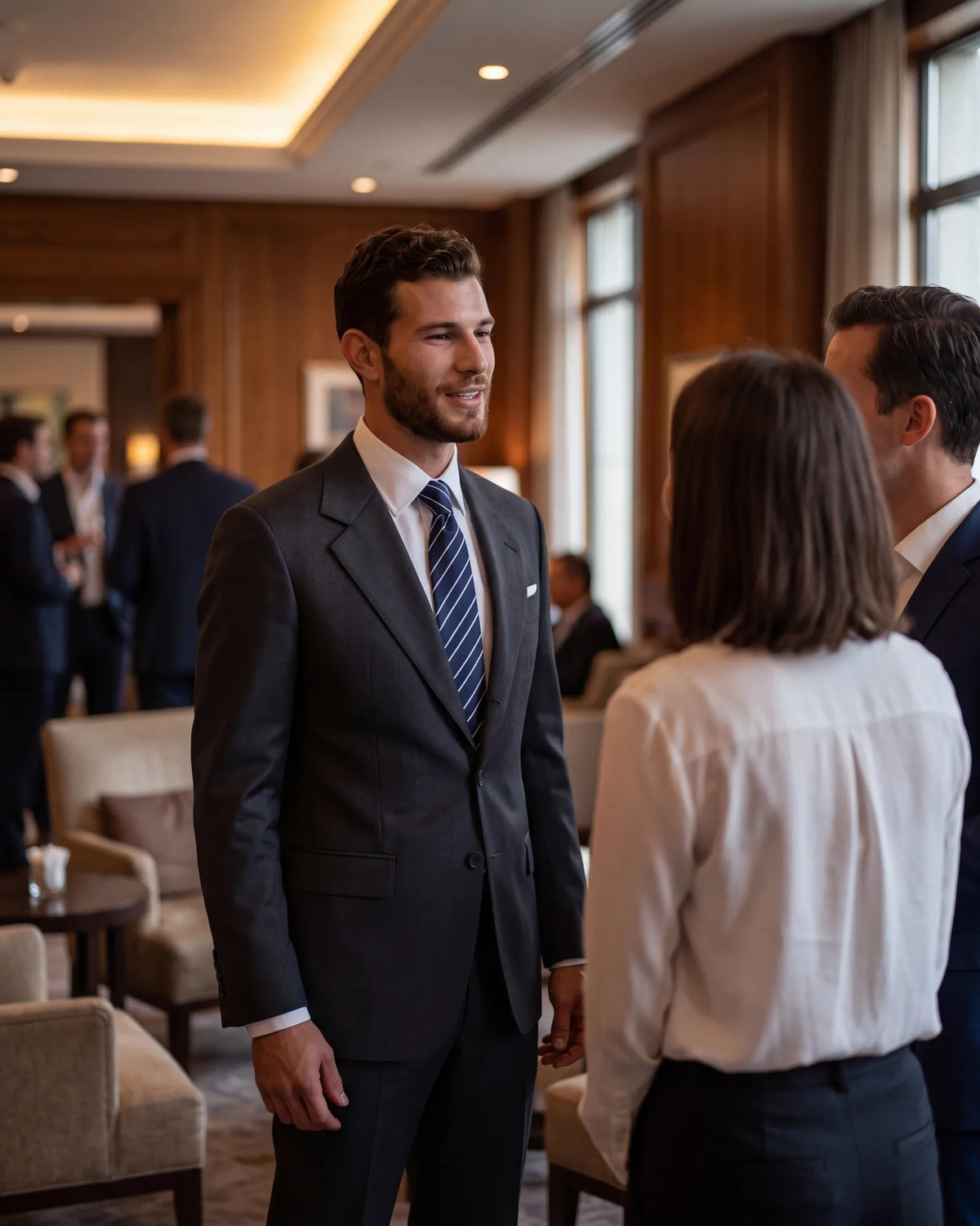 Treat work drinks as part of the job. A matched dark suit, a white shirt and a silk tie in a restrained pattern keep it conservative.