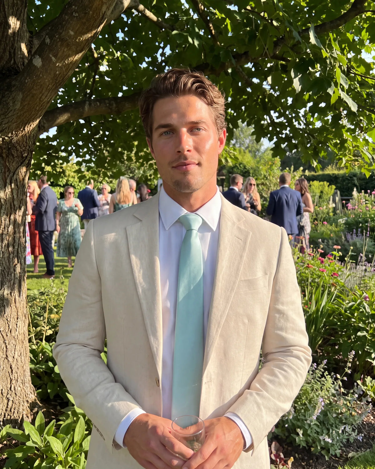 Choose a linen blend for a hot afternoon event. It handles heat without dropping below the code, and pale tan suits daylight.