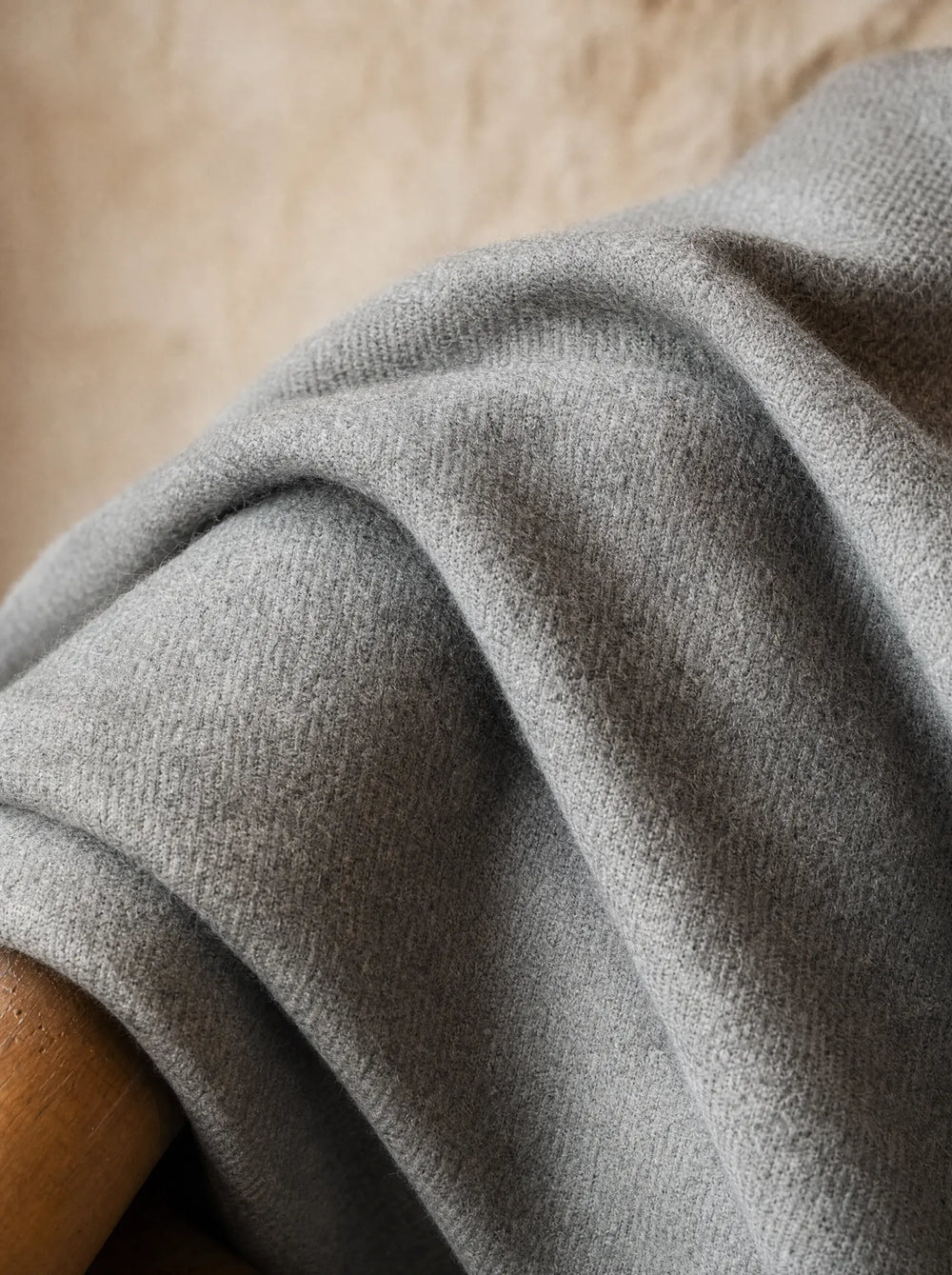 Close-up of grey flannel wool fabric showing the soft brushed nap and dense weave that makes VBC flannel the winter reference cloth