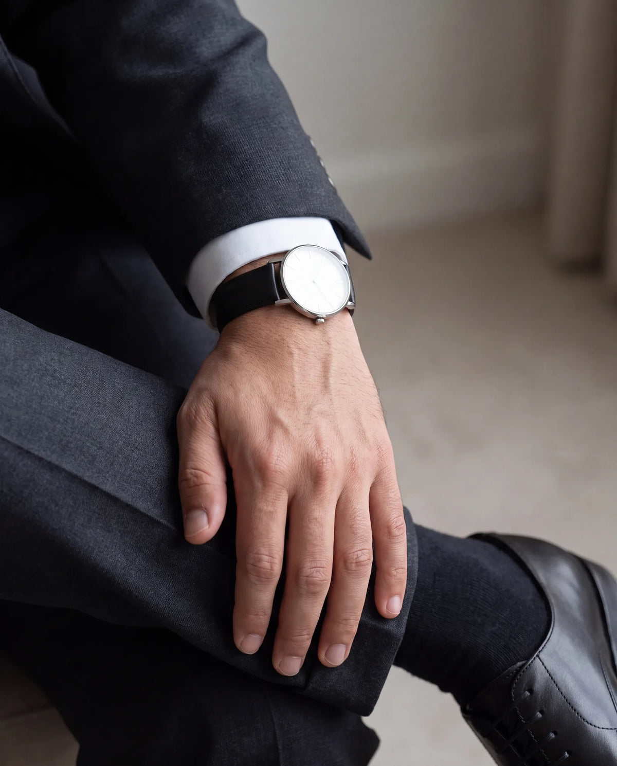 Skip statement jewelry. A simple watch and a wedding band are enough.