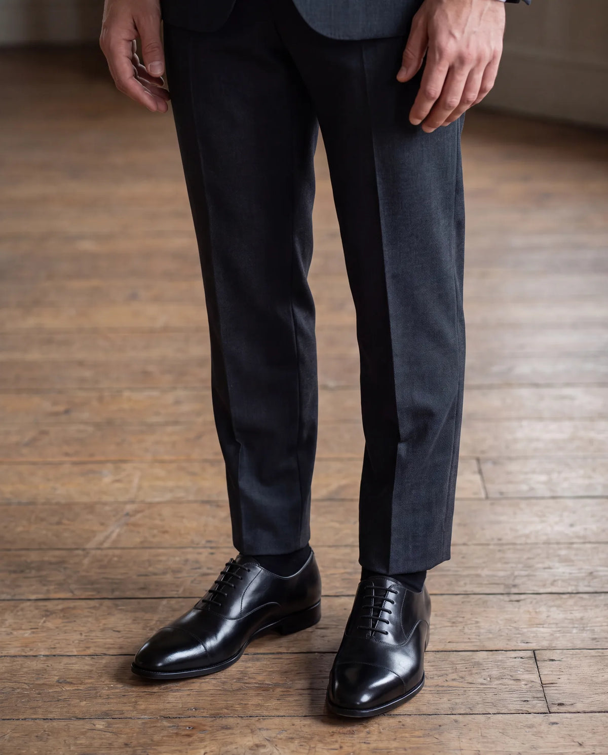 These trousers meet the oxfords cleanly, with no pooling. Sit down to check that socks, not skin, show at the hem.