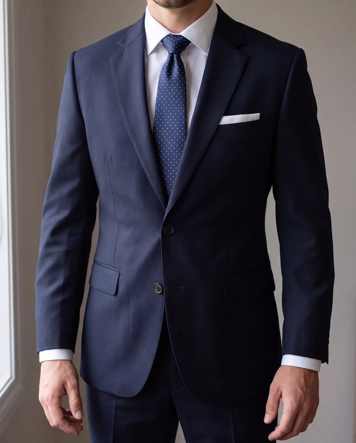 A small pin dot on a dark navy tie is quiet enough for a funeral. Skip bright, bold or novelty patterns.