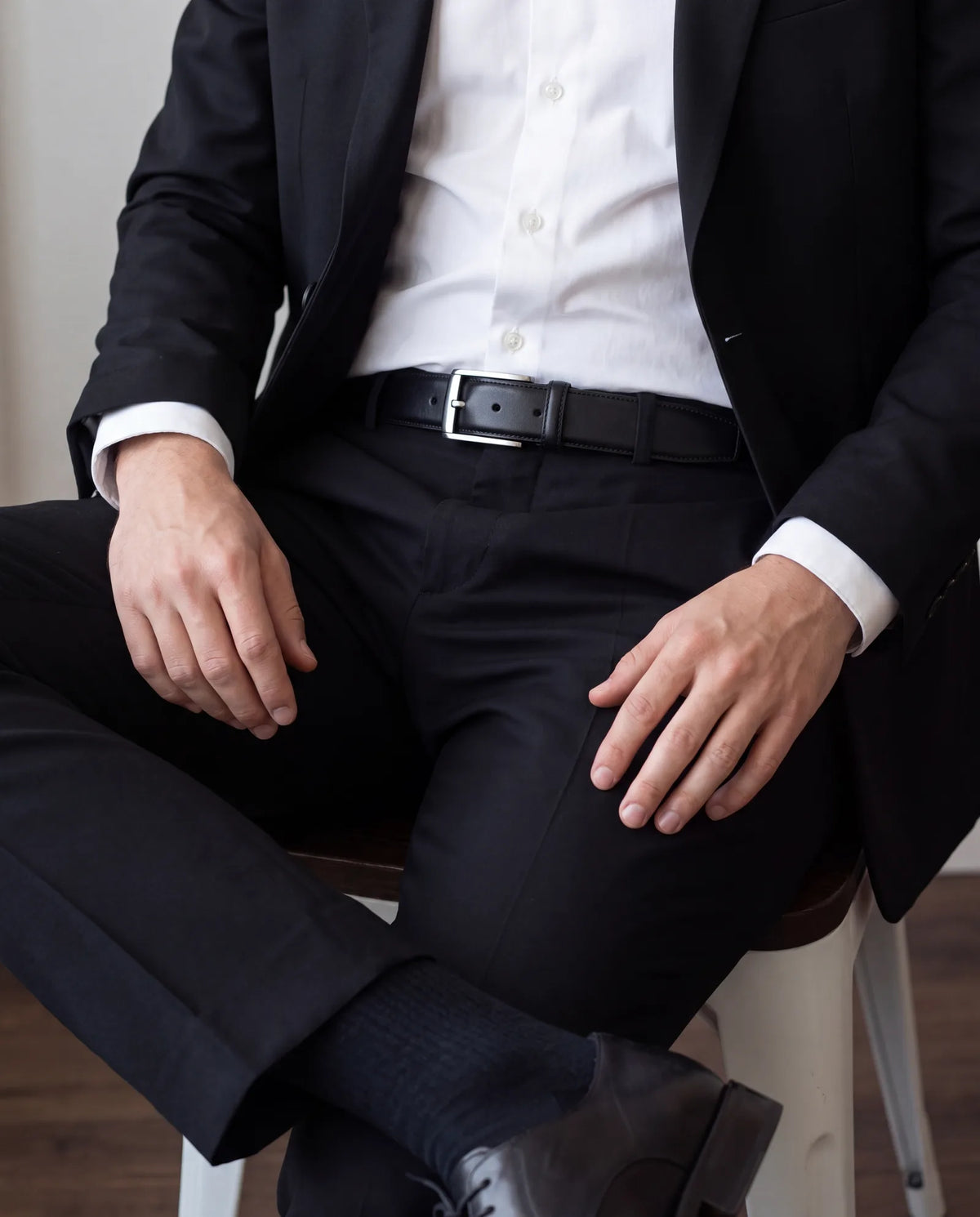 The belt is plain black leather, to match plain black lace-up shoes.