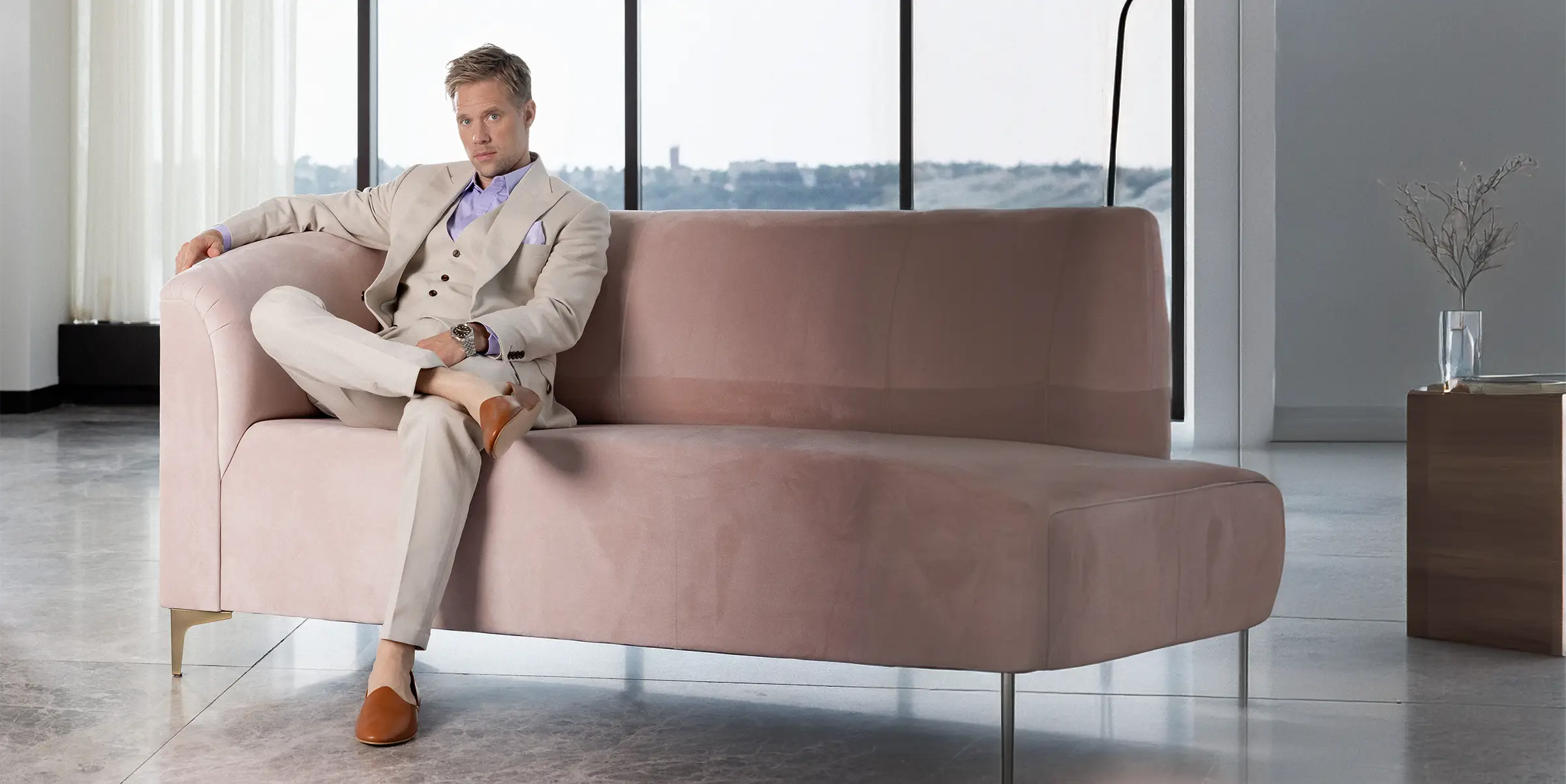 man on couch in tan suit