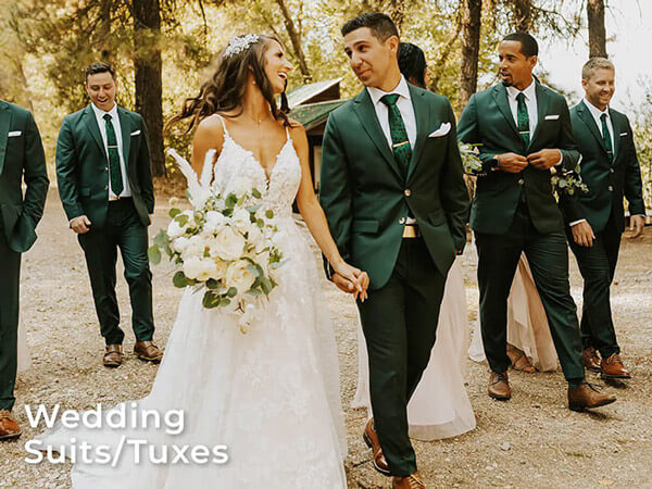 a wedding party in green suits next to the bride