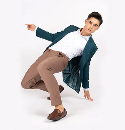 green jacket and tan pants on model stretching
