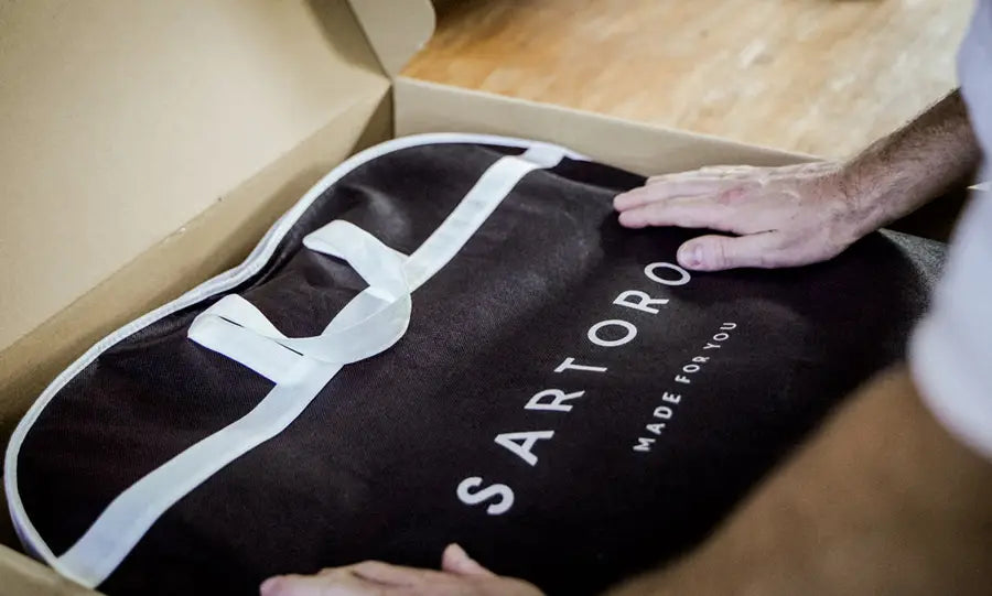 a suit bag being packaged into a shipping box