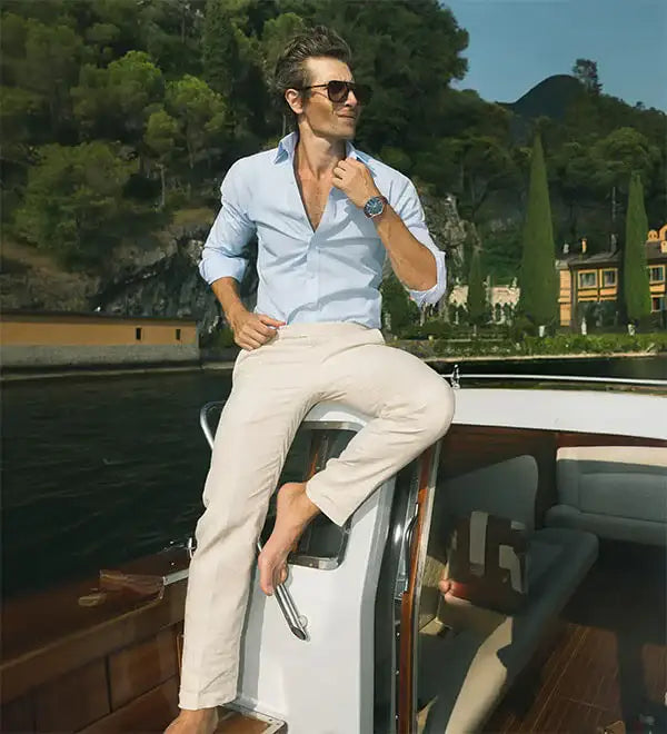 model in blue pants standing on beach