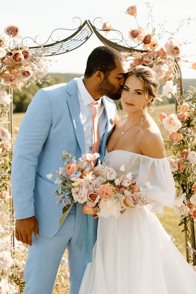 bride and groom in light blue linen suit