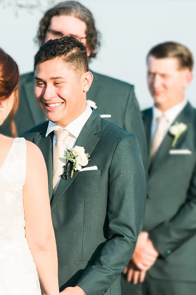 Customer in green wedding suit with bride.
