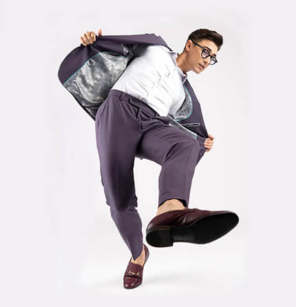 model in purple suit kicking forward