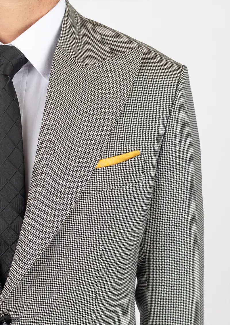 close up of gold pocket square in suit chest pocket