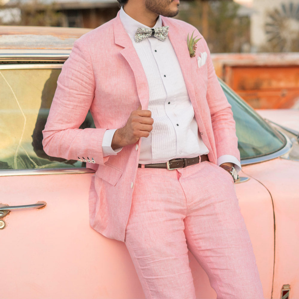 wedding couple in ghost town. groom in pink suit.