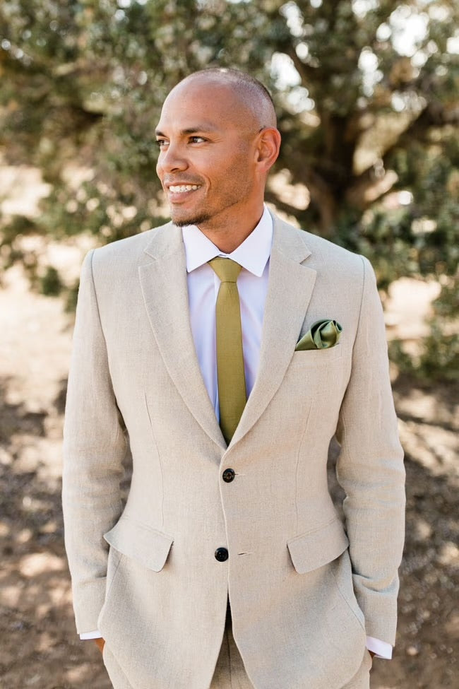groom in taupe suit smiling