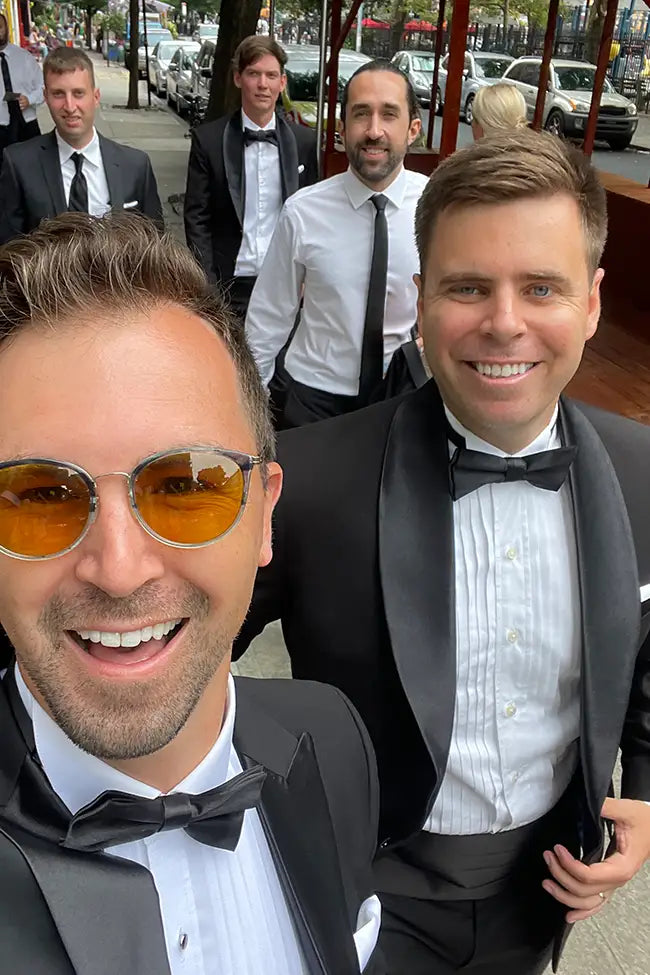 Wedding party in black tuxedos on the street