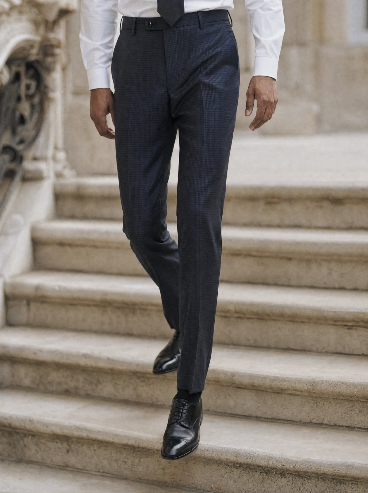 Graphite blue microcheck trousers with black oxfords on an opera house stone staircase317