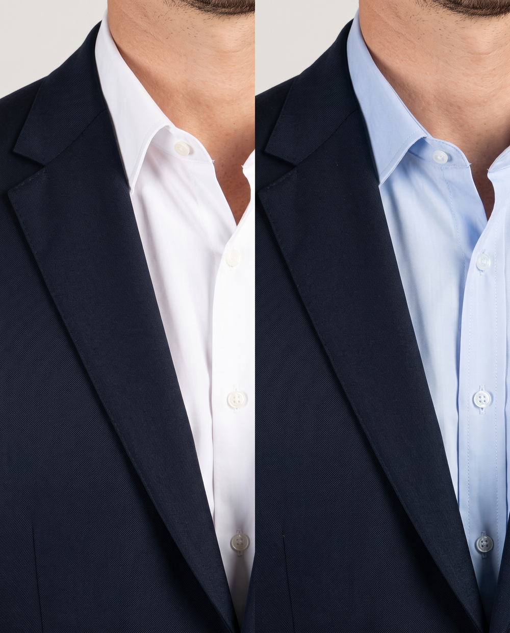 A navy suit jacket shown with a white shirt on one side and a light blue shirt on the other, comparing shirt contrast.