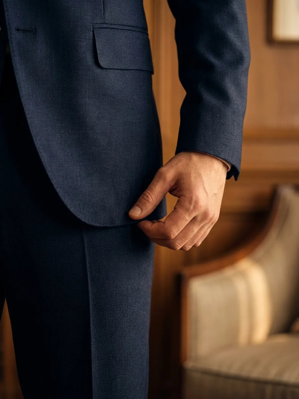 The jacket-length test: a hand at the side with fingers reaching the suit jacket hem.