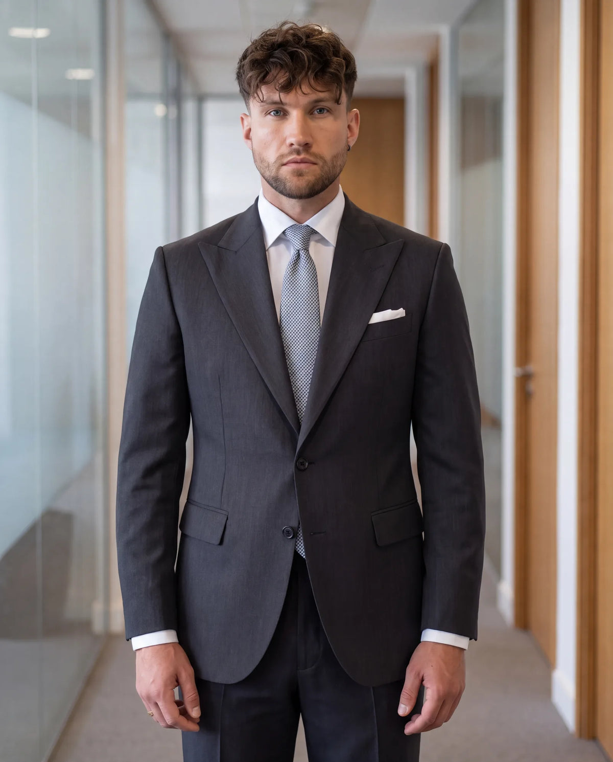 Skip black and wear charcoal instead. Along with navy, it is correct for most interviews.
