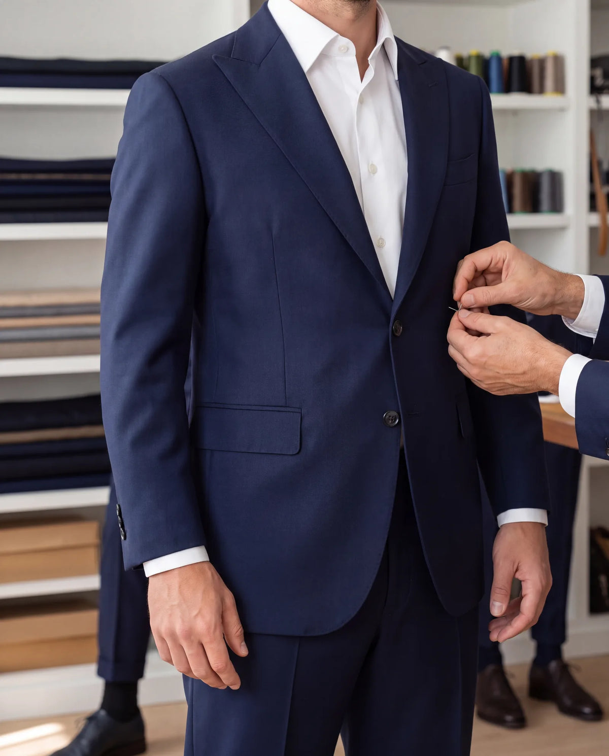 Sleeves and hems are quick work for a tailor. Shoulders are not, so pick the jacket that fits there first.