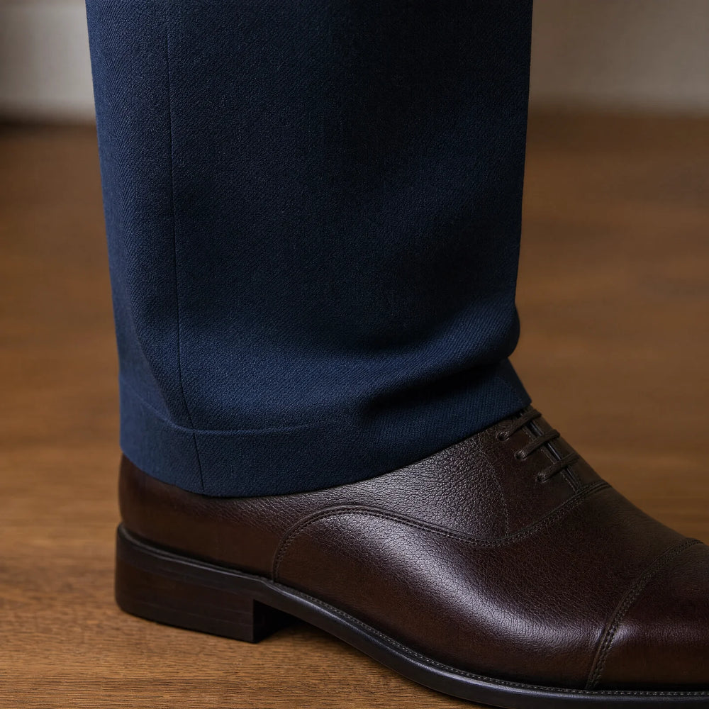 Close view of trouser break over a dress shoe