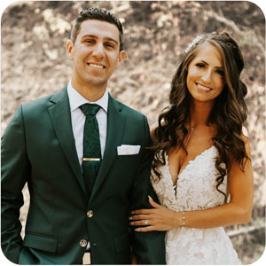 wedding couple, groom in a dark green suit and bride in a white dress